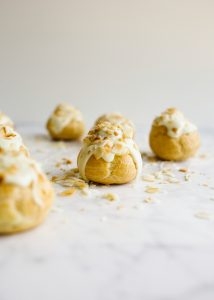 How to Make Pate a Choux and Coconut Cream Pie Puffs How to Make Pate a Choux and Coconut Cream Pie Puffs by Wood and Spoon. This is a step by step photographic tutorial on how to prepare French puff pastry with eggs and flour to make cream puffs profiteroles eclairs etc. Coconut cream pie custard filling is stuffed in the bites and topped with white chocolate and toasted coconut. For more on how to make this bite sized delicate fancy dessert read the recipe on thewoodandspoon.com