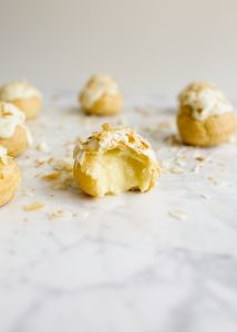 How to Make Pate a Choux and Coconut Cream Pie Puffs How to Make Pate a Choux and Coconut Cream Pie Puffs by Wood and Spoon. This is a step by step photographic tutorial on how to prepare French puff pastry with eggs and flour to make cream puffs profiteroles eclairs etc. Coconut cream pie custard filling is stuffed in the bites and topped with white chocolate and toasted coconut. For more on how to make this bite sized delicate fancy dessert read the recipe on thewoodandspoon.com